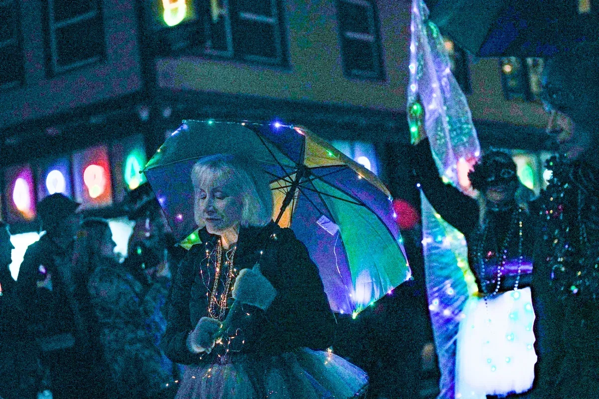 Mississippi Avenue second line reveler under umbrella